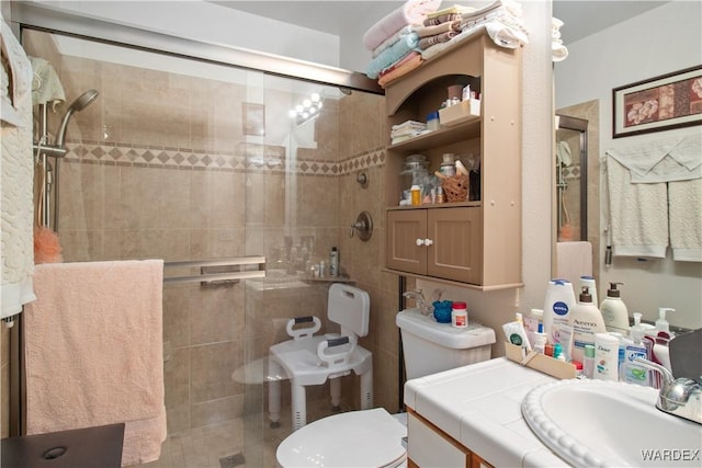 full bath featuring a stall shower, vanity, and toilet