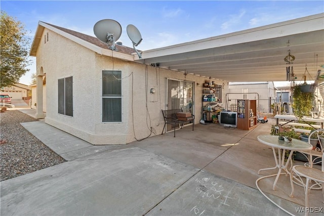 back of house featuring a patio area and stucco siding