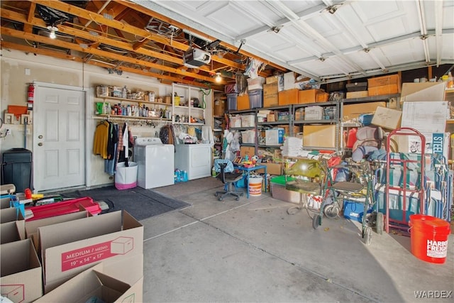 garage with washing machine and dryer and a garage door opener