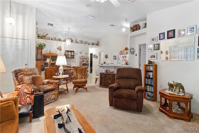 living room featuring light carpet, visible vents, and a ceiling fan