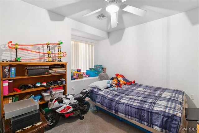 carpeted bedroom with visible vents and ceiling fan