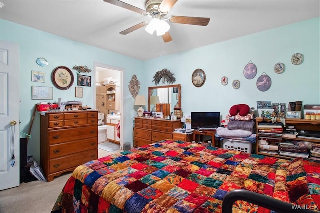 bedroom with light carpet, a ceiling fan, and connected bathroom