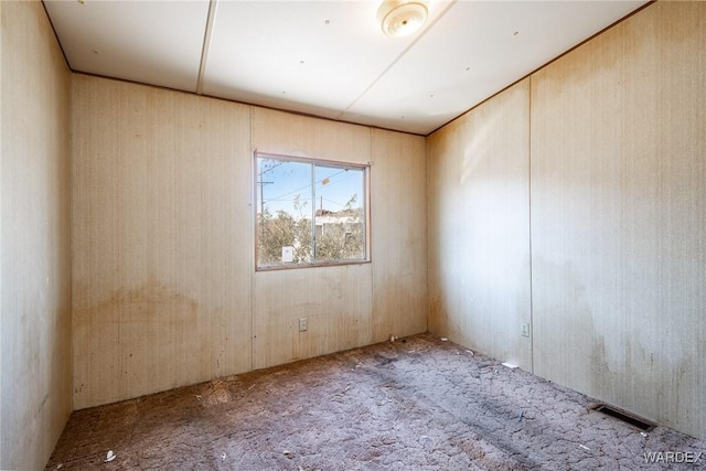 carpeted empty room with visible vents