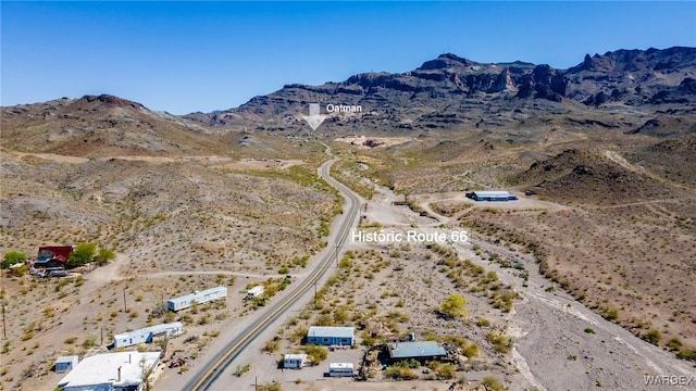 birds eye view of property featuring a rural view, a mountain view, and a desert view