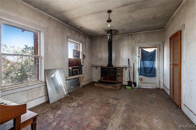 unfurnished living room with a wood stove