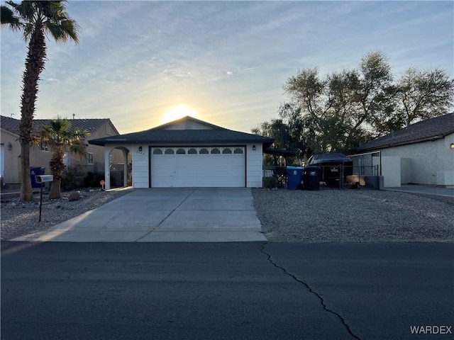 ranch-style house with a garage and concrete driveway