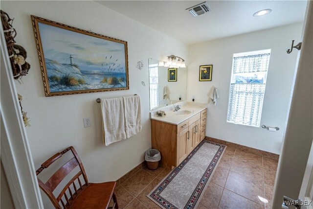 bathroom featuring tile patterned flooring, visible vents, and vanity