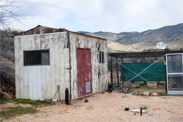 view of outbuilding featuring a mountain view and an outdoor structure