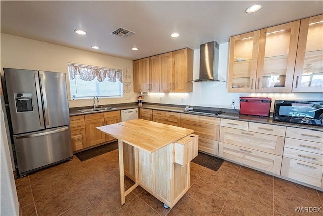 kitchen with visible vents, wall chimney exhaust hood, glass insert cabinets, black appliances, and a sink