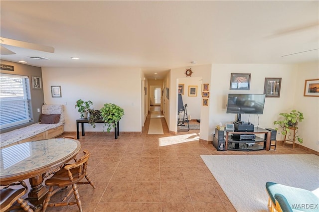 living area featuring light tile patterned floors, recessed lighting, visible vents, a ceiling fan, and baseboards