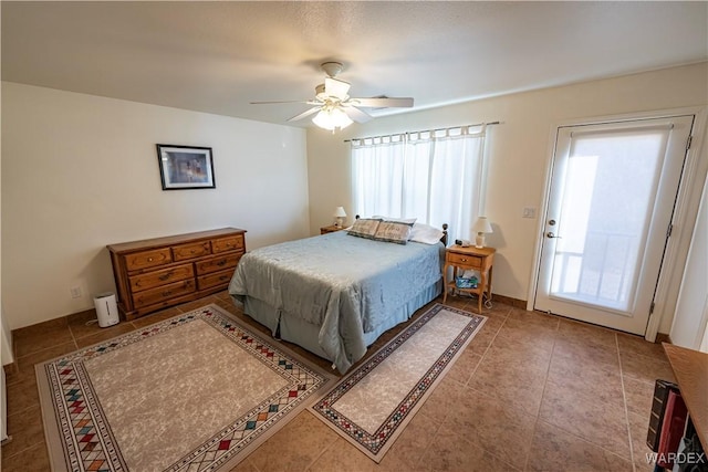 tiled bedroom with multiple windows and a ceiling fan