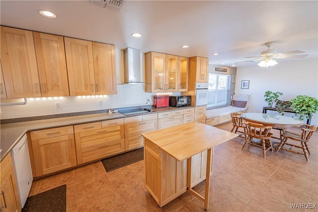 kitchen featuring visible vents, wall chimney exhaust hood, glass insert cabinets, black appliances, and light brown cabinets