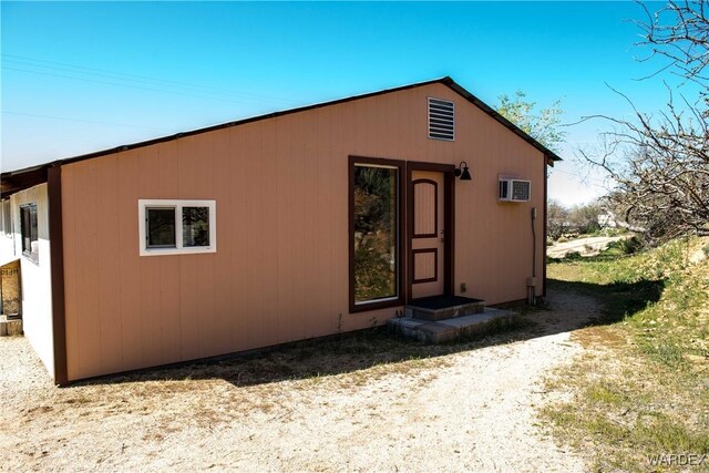 back of house featuring a wall mounted AC