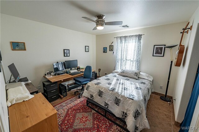 tiled bedroom with ceiling fan and visible vents