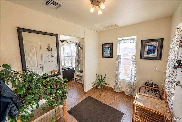 tiled foyer featuring visible vents and a wealth of natural light