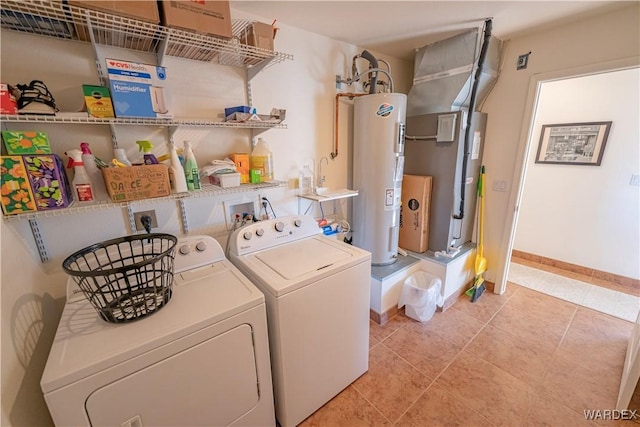 washroom featuring light tile patterned floors, washing machine and dryer, electric water heater, laundry area, and baseboards