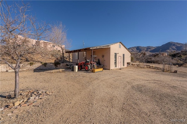 rear view of house featuring a mountain view