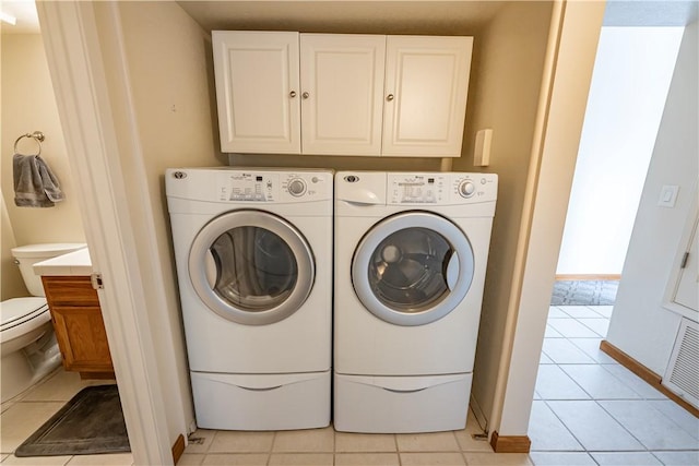 1800 Clubhouse Dr Unit D41, Bullhead City, AZ 86442 - washroom with washing machine and clothes dryer, light tile patterned floors, cabinet space, and baseboards