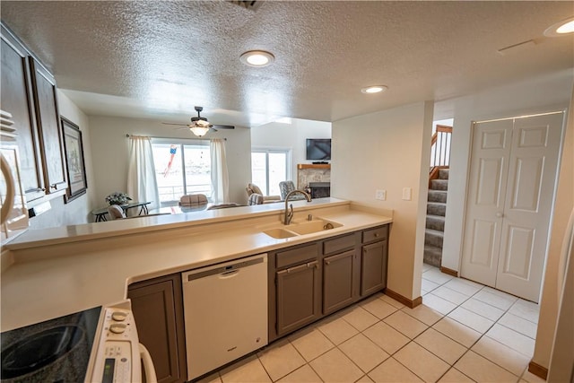 1800 Clubhouse Dr Unit D41, Bullhead City, AZ 86442 - kitchen with dishwashing machine, a sink, a fireplace, a textured ceiling, and a ceiling fan