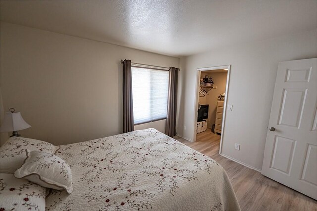 1800 Clubhouse Dr Unit D41, Bullhead City, AZ 86442 - bedroom with light wood-style floors, a walk in closet, and baseboards