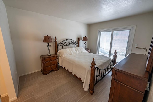 1800 Clubhouse Dr Unit D41, Bullhead City, AZ 86442 - bedroom with access to outside, wood finished floors, and baseboards