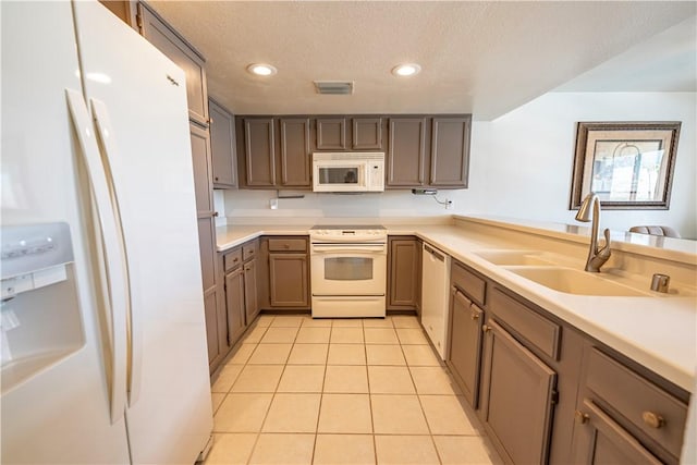 1800 Clubhouse Dr Unit D41, Bullhead City, AZ 86442 - kitchen with white appliances, a sink, light tile patterned floors, a textured ceiling, and light countertops