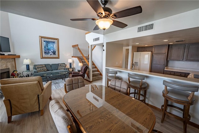 1800 Clubhouse Dr Unit D41, Bullhead City, AZ 86442 - dining space featuring a fireplace, wood finished floors, stairs, and ceiling fan