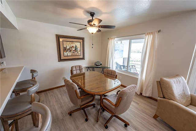1800 Clubhouse Dr Unit D41, Bullhead City, AZ 86442 - dining area with light wood-style floors, a ceiling fan, and baseboards