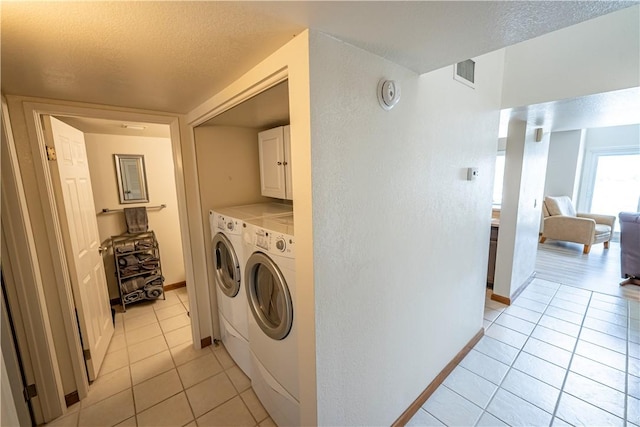 1800 Clubhouse Dr Unit D41, Bullhead City, AZ 86442 - laundry room featuring washer and dryer, light tile patterned floors, a textured ceiling, and baseboards