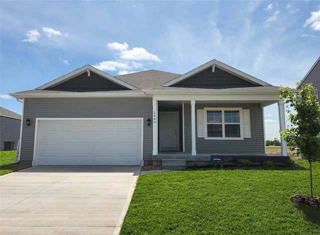 view of front of house featuring central AC unit, a garage, and a front lawn