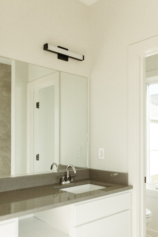 bathroom featuring vanity and toilet