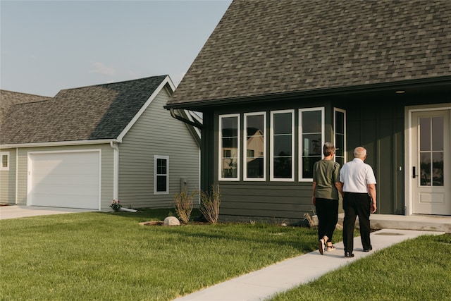 view of home's exterior featuring a garage and a lawn