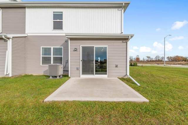 rear view of house featuring central AC, a yard, and a patio