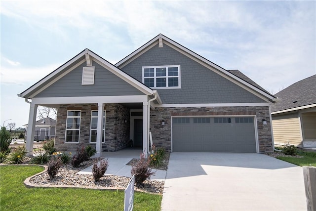 craftsman-style home featuring a front yard, a garage, and covered porch