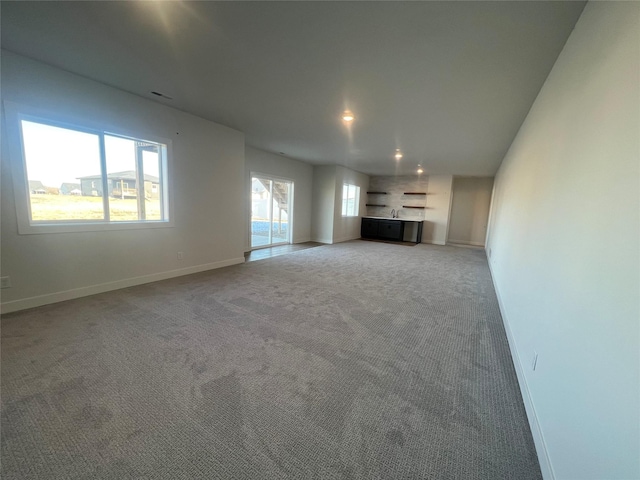 unfurnished living room with light carpet