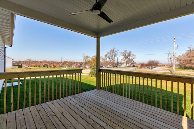 wooden terrace featuring a yard and ceiling fan