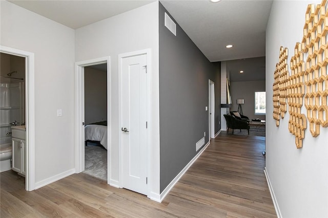 hallway with light hardwood / wood-style flooring