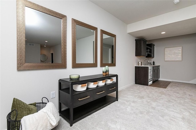 hallway featuring carpet floors and sink