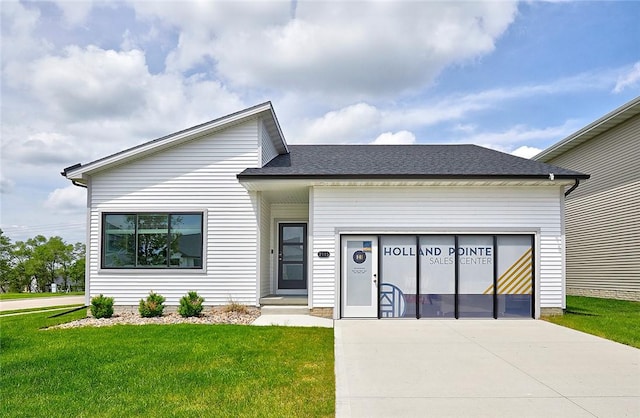 view of front facade with a garage and a front lawn