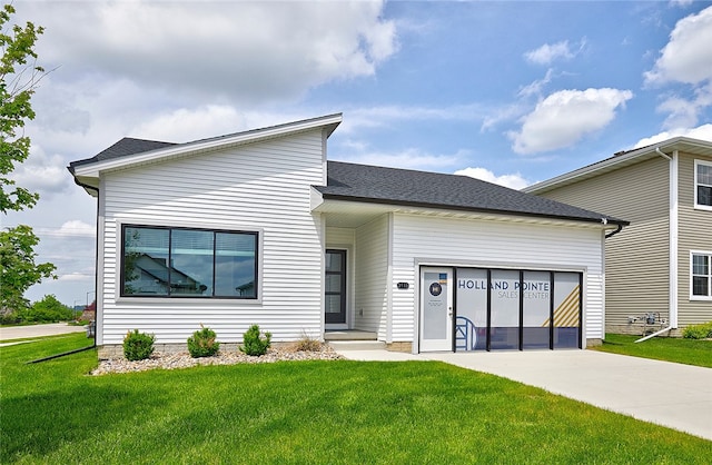 view of front facade with a front yard and a garage