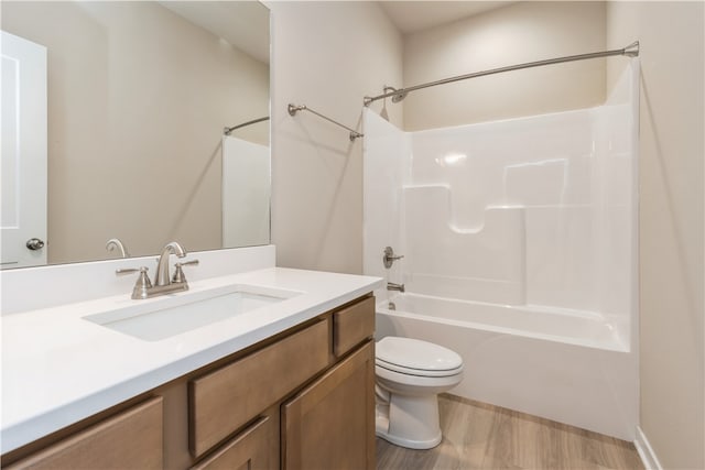 full bathroom featuring shower / washtub combination, toilet, vanity, and hardwood / wood-style flooring