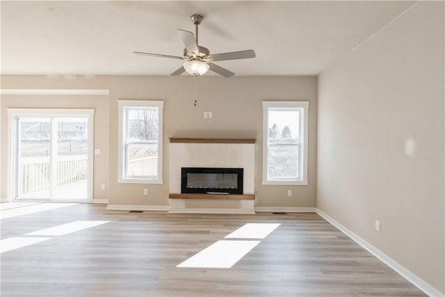 unfurnished living room with ceiling fan and light hardwood / wood-style flooring