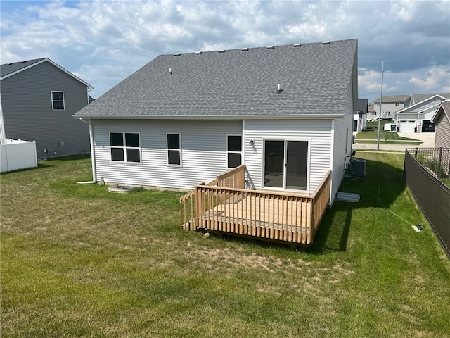 back of house with a wooden deck, central AC, and a lawn