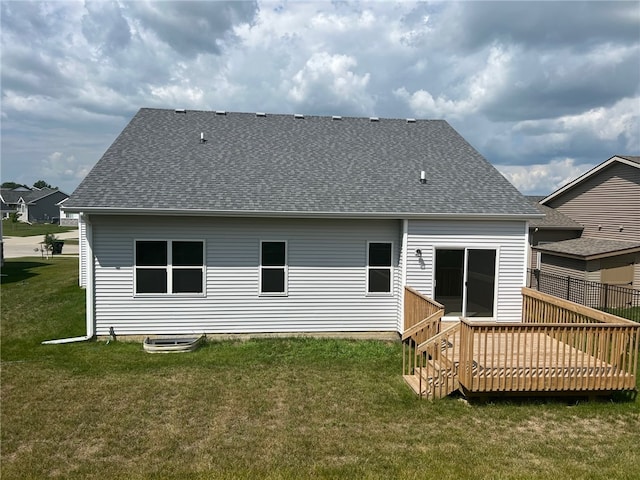 back of house with a deck and a yard