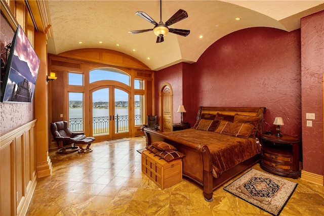 bedroom featuring light tile floors, ceiling fan, french doors, a water view, and access to outside