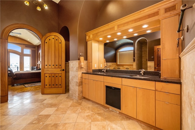 bathroom with tile flooring, high vaulted ceiling, and oversized vanity