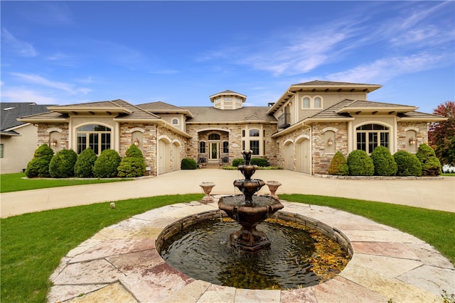 mediterranean / spanish home featuring french doors