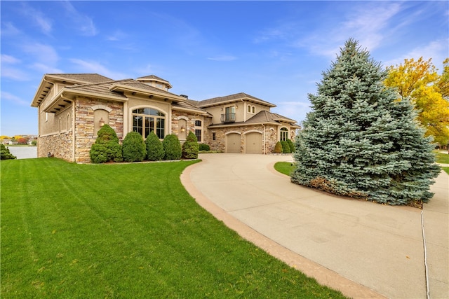 mediterranean / spanish-style home with a front yard and a garage