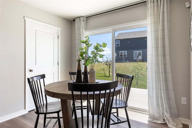 dining space with hardwood / wood-style floors