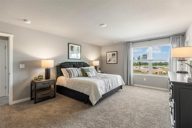 bedroom featuring carpet flooring and a textured ceiling